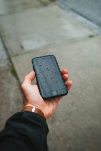 person holding black iphone case